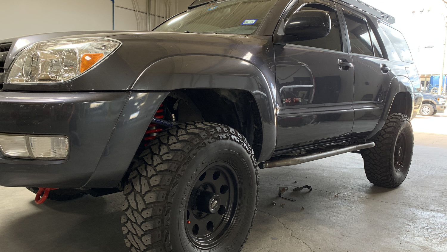 Front drivers side view of gray 4Runner with Trail Edition bolt on rock sliders - Cali Raised LED