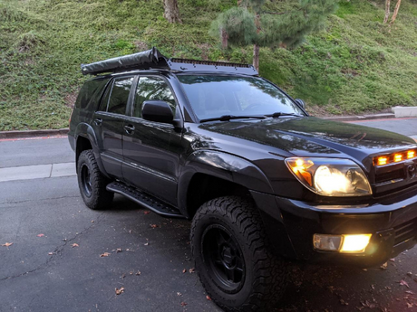 Front passenger side view of Toyota 4Runner with Step Edition bolt on rock sliders - Cali Raised LED