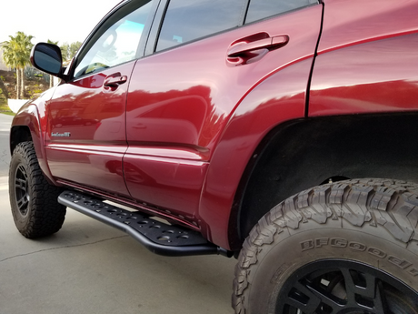 Rear drivers side view of Toyota 4Runner with Step Edition bolt on rock sliders - Cali Raised LED