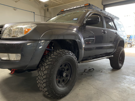 Front drivers side view of gray 4Runner with Trail Edition bolt on rock sliders - Cali Raised LED